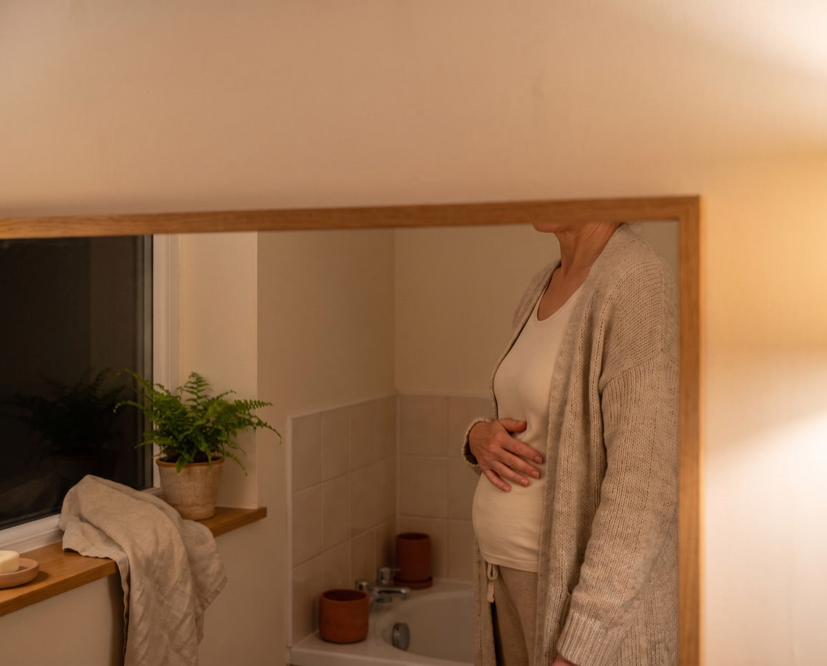 Photo: same mirror, loose cardigan, evening lamp light